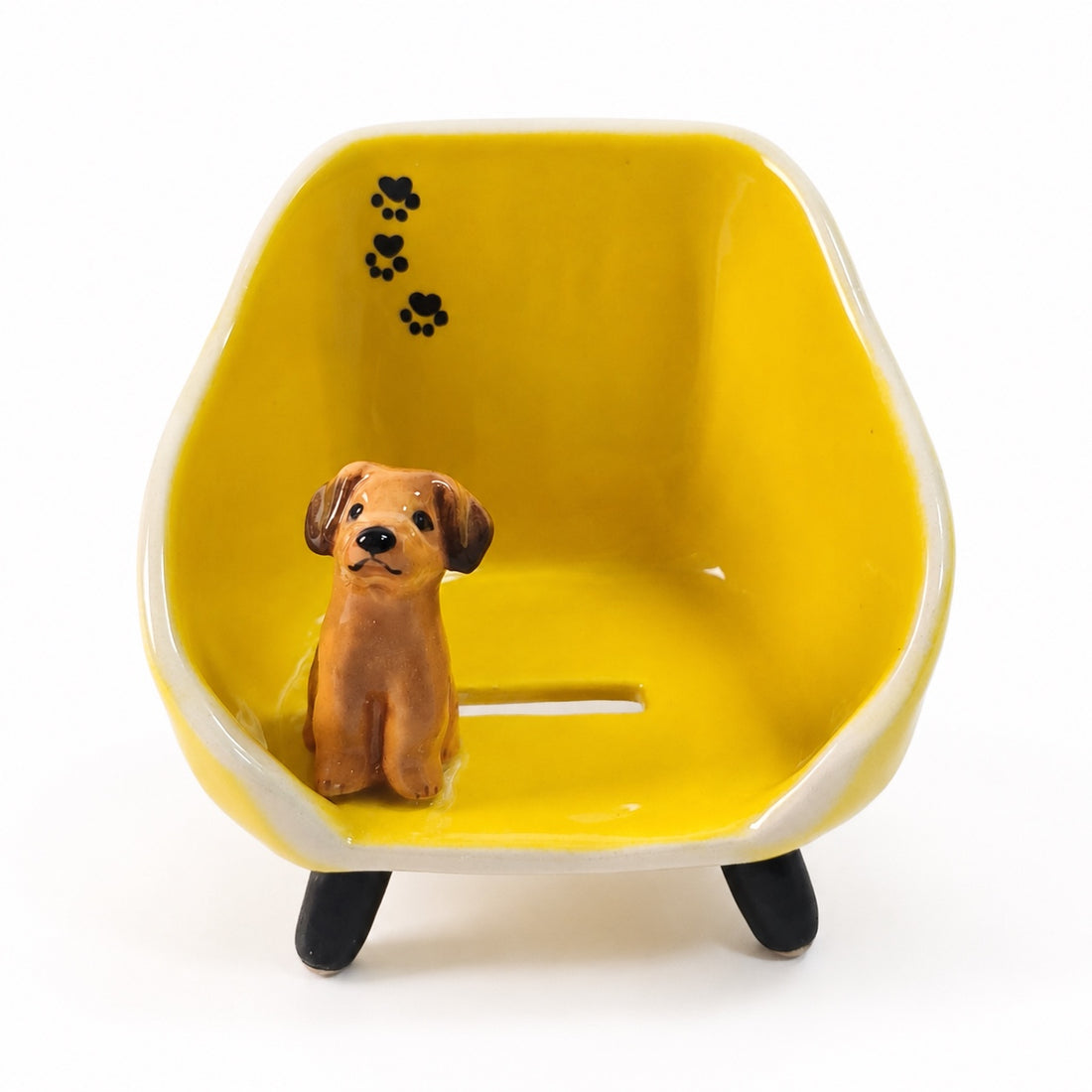 Custom pet phone stand in yellow with a small brown dog figurine and paw-print decoration.