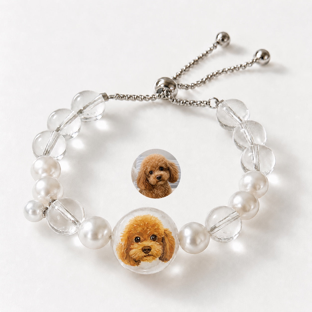 Custom pet face bracelet with two curly brown dog portrait charms and pearl accents.