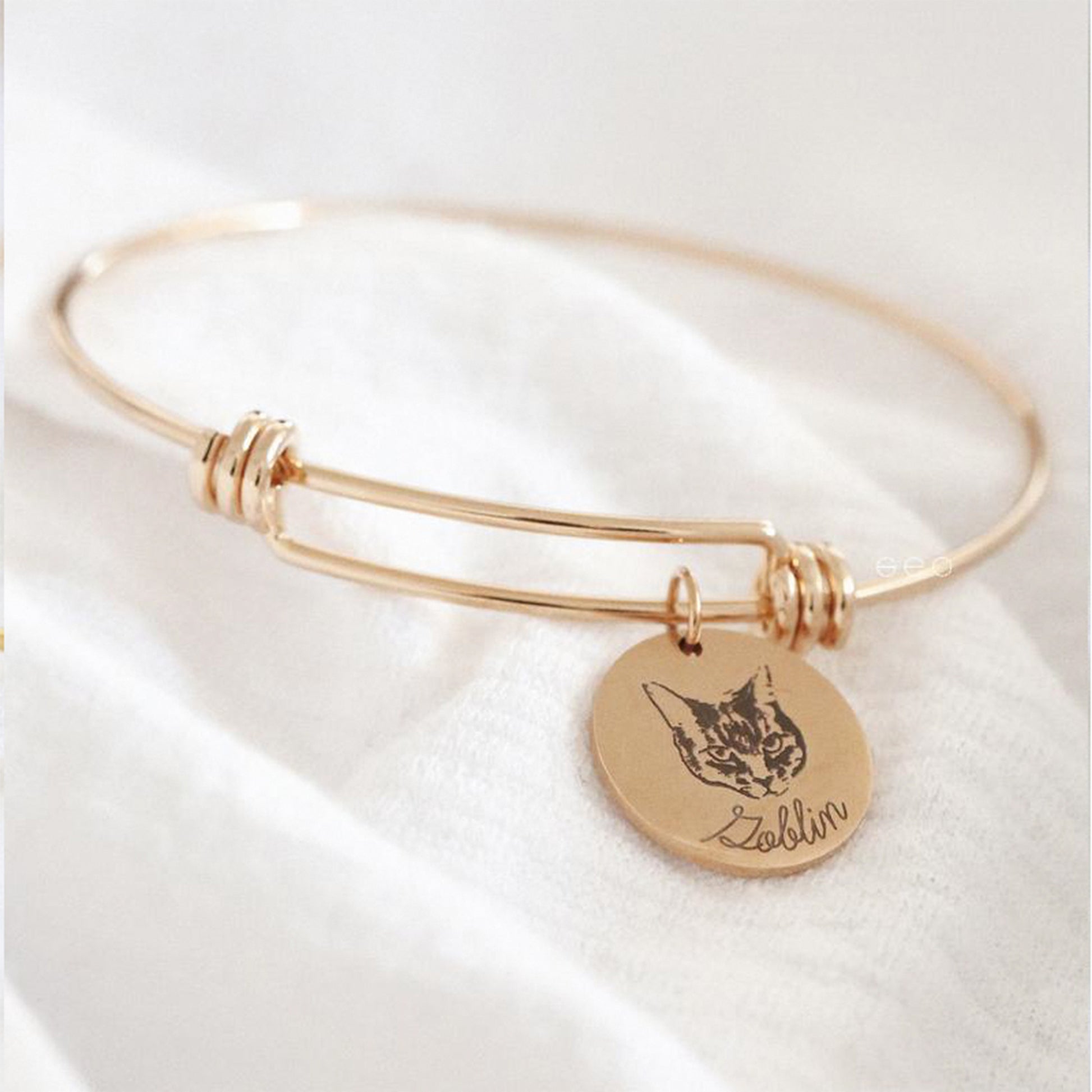 Engraved pet portrait bangle in rose gold tone with a single cat portrait charm.
