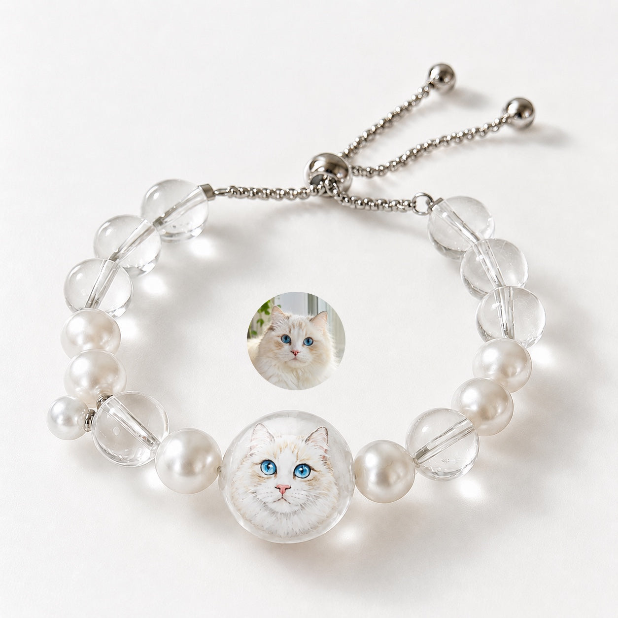 Custom pet face bracelet with two white cat portrait charms, pearls, and clear crystal beads.