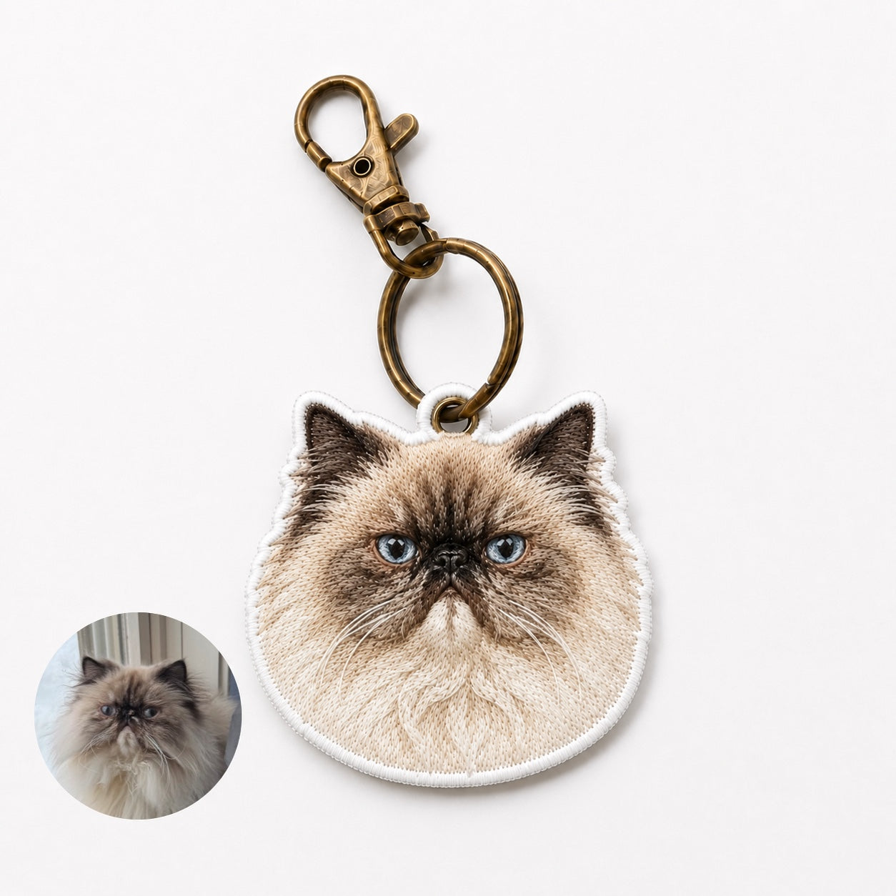 Product image of an embroidered pet portrait keychain with a tatami-style custom pet face.
