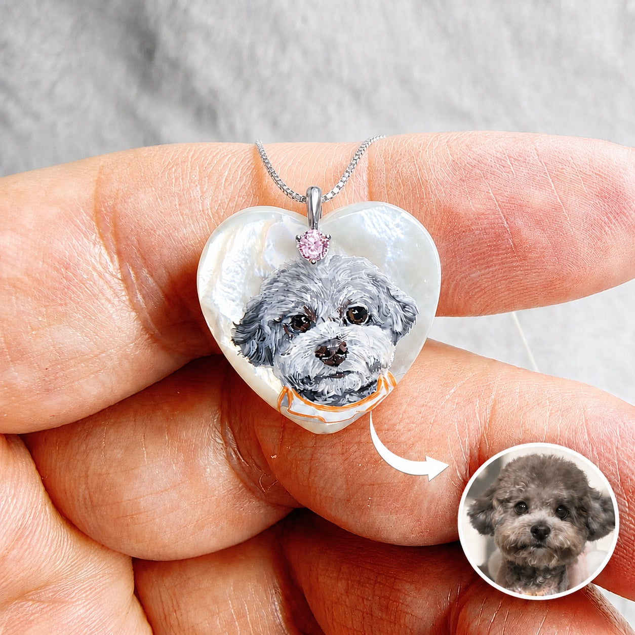 Hand-painted pet portrait pendant with a gray dog painted on a heart-shaped mother-of-pearl piece.