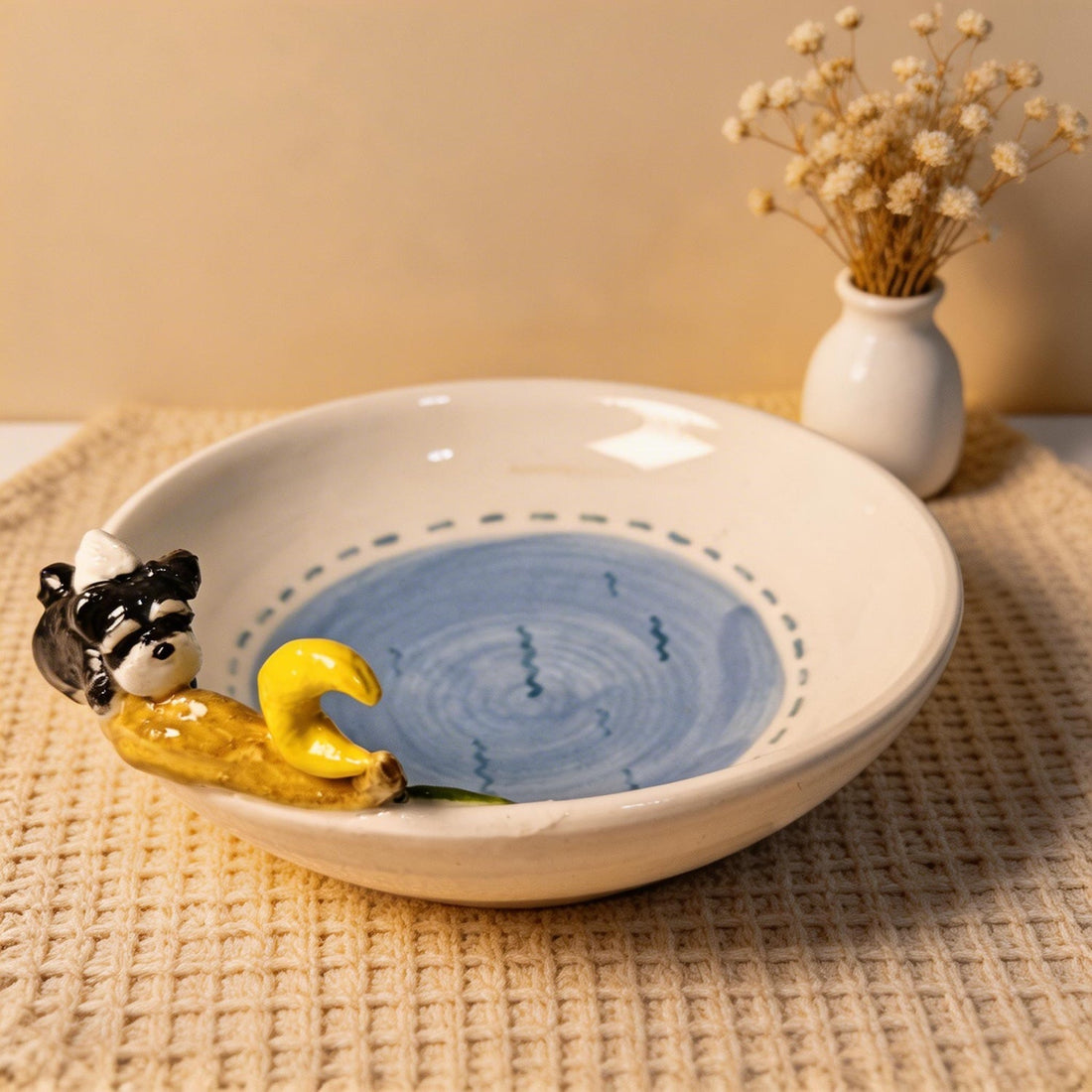 Front view of a ceramic plate with a custom 3D pet figure beside a crescent moon.