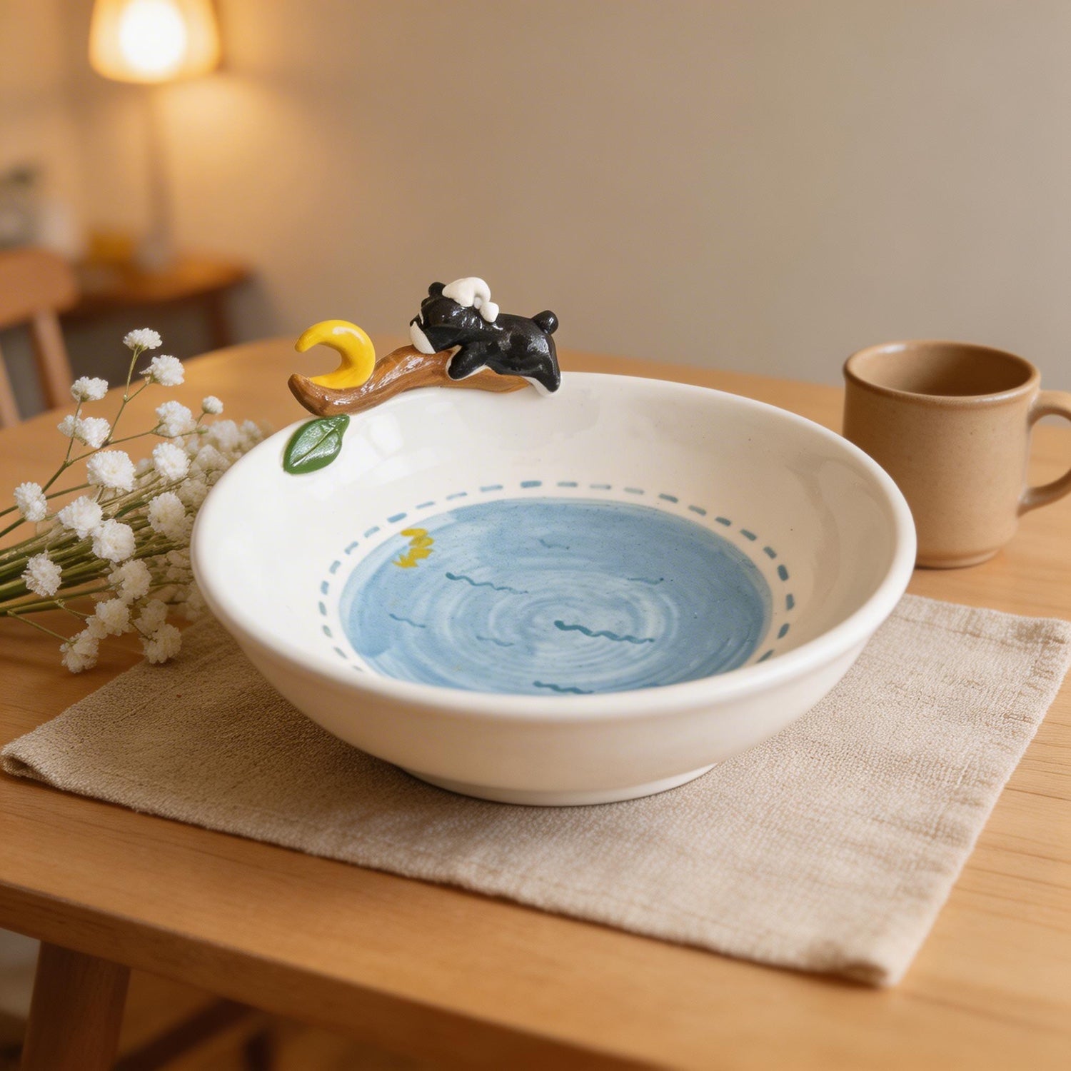 Angled view of a custom moon plate showing the raised pet figure and ceramic relief.