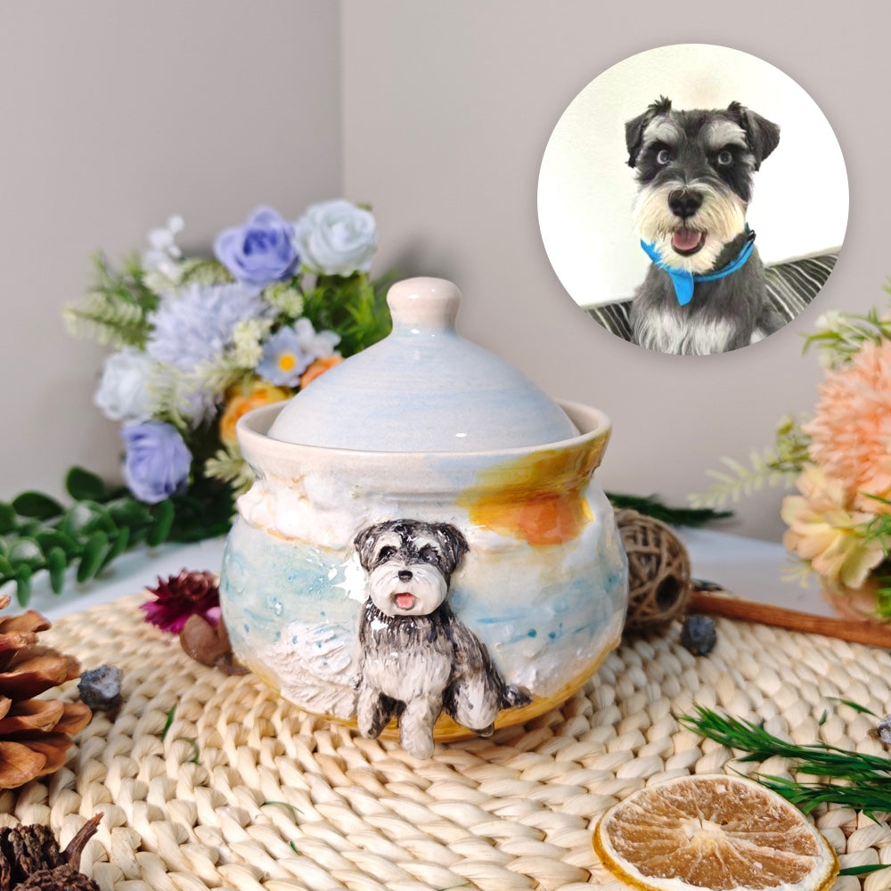 Front view of a custom ceramic pet photo urn in a beach scene design with a black and white dog sculpture and fitted lid.