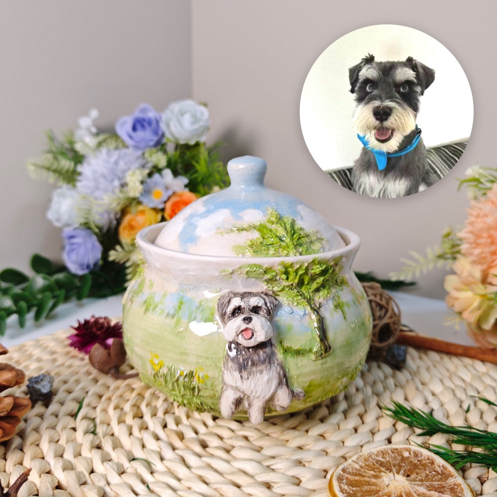 Back view of a custom ceramic pet urn showing the hand-painted green landscape and raised tree details.