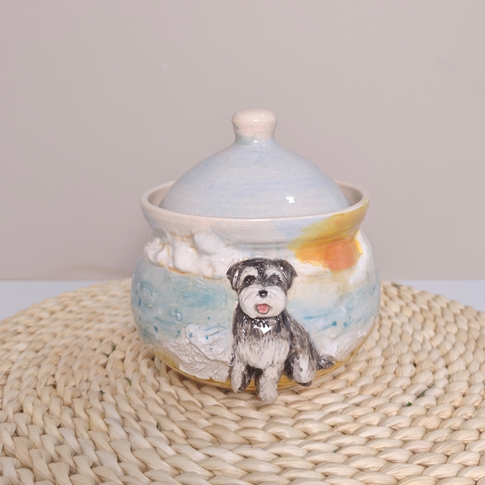 Front workshop view of a custom ceramic pet urn in a forest scene with a raised gray dog portrait and fitted lid.