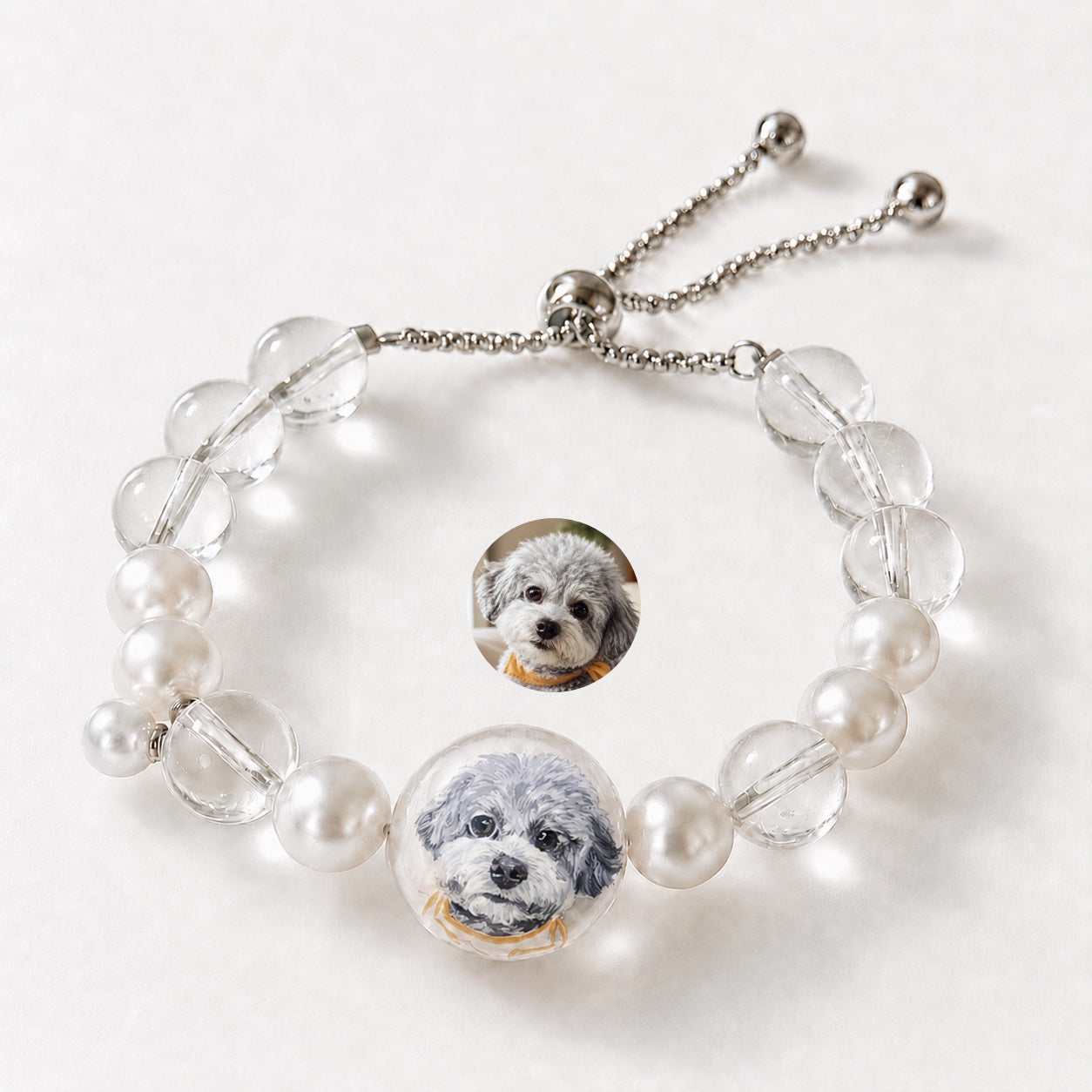 Custom pet face bracelet with two gray dog portrait charms and clear crystal beads.