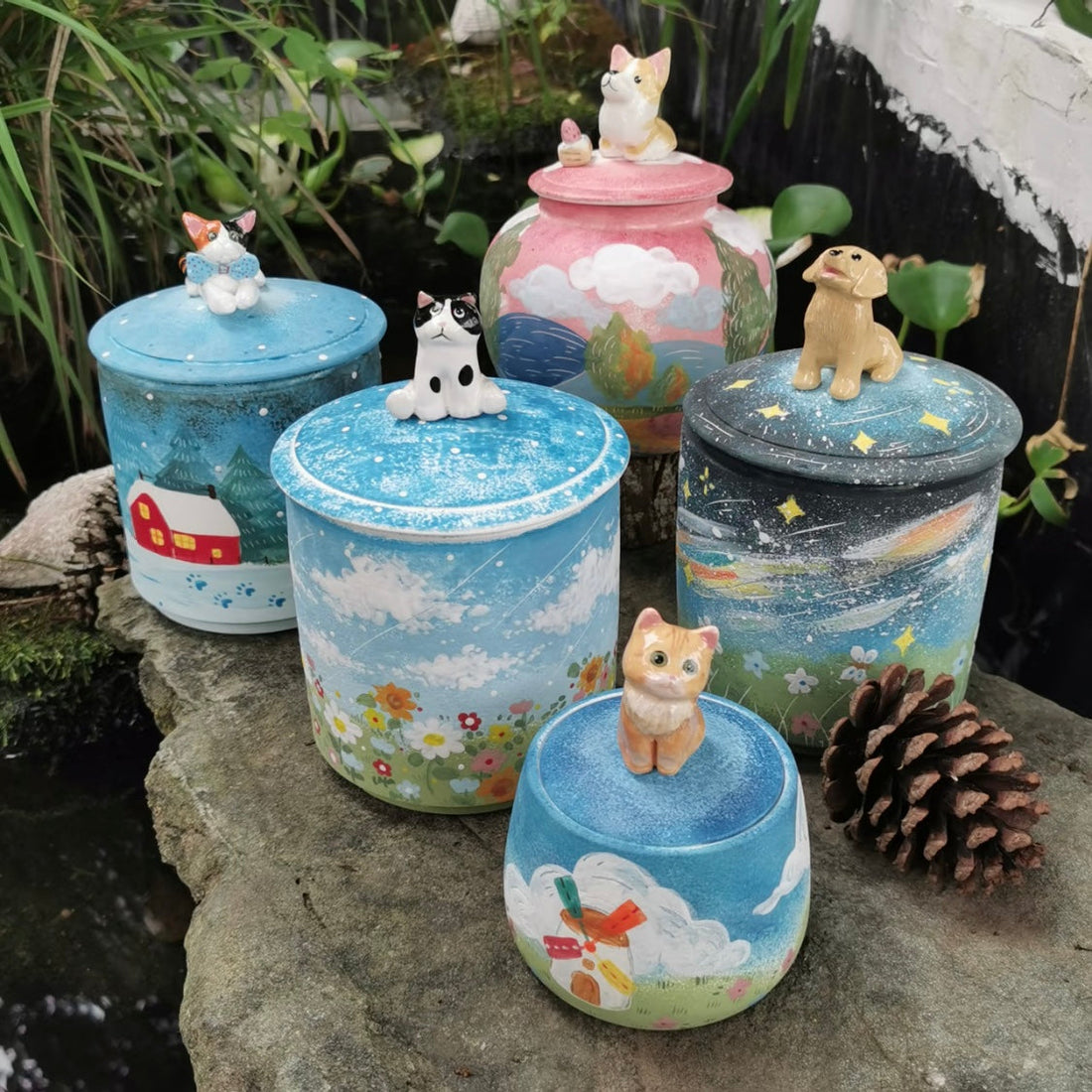 Handmade ceramic pet urn for ashes with a painted body and 3D pet figurine lid.
