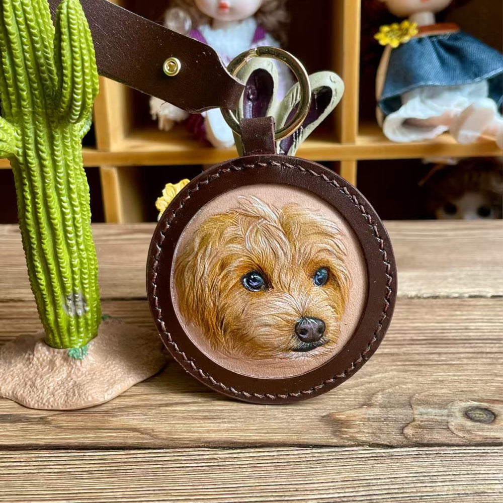 Front view of a handmade round leather keychain with a custom pet portrait.