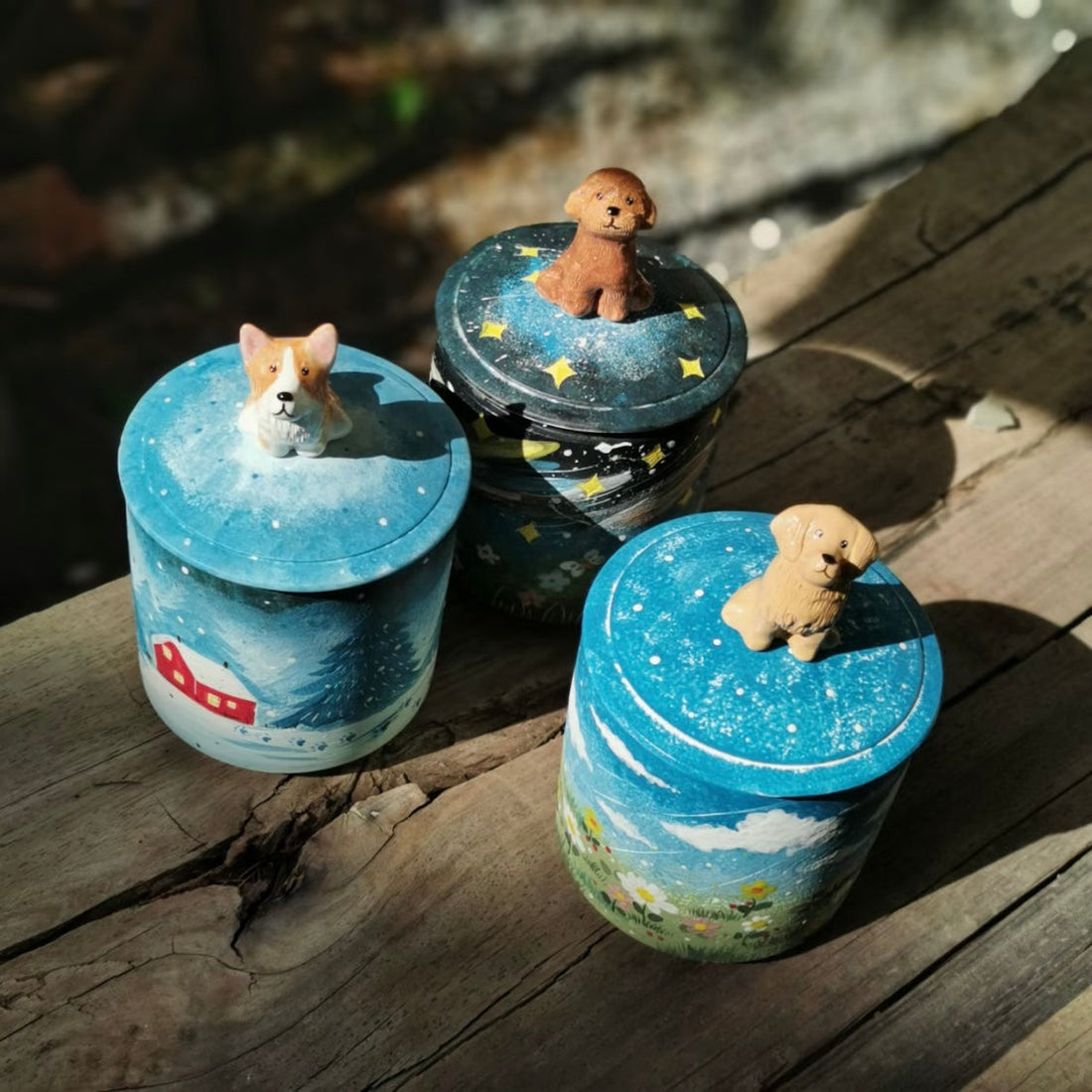 Handmade ceramic pet urn for ashes with a painted body and 3D pet figurine lid.