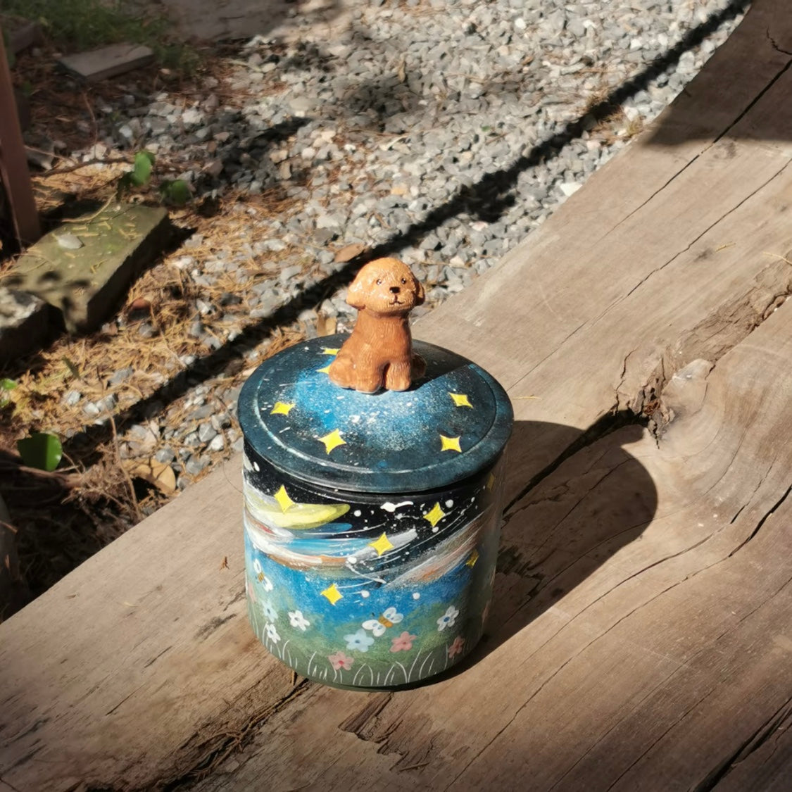 Ceramic pet urn displayed on a shelf as a memorial keepsake.